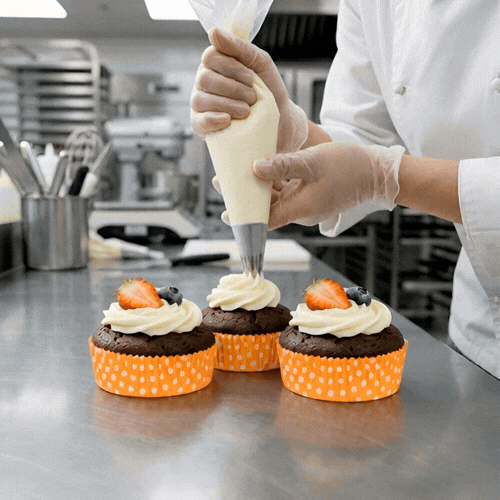 Panificio 4 oz Round Polka-Dotted Hot Orange Paper Baking Cup - Ridged - 3 1/2" x 3 1/2" x 1" - 200 count box