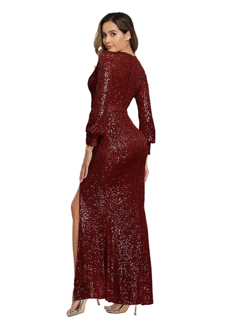 Woman wearing a burgundy sequin dress with a high slit on a gray background