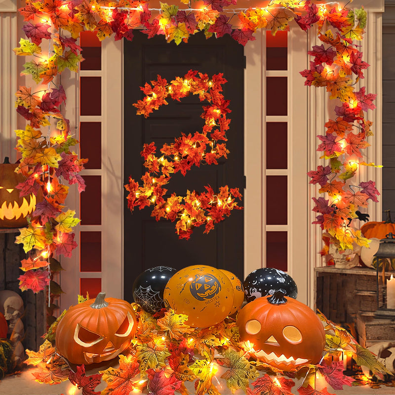 Decorative setup with pumpkins, balloons, and autumn leaves for Halloween.