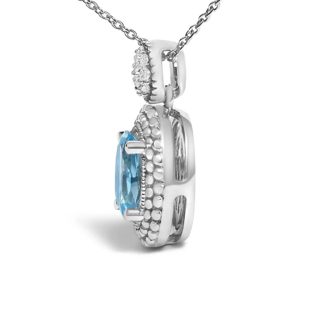 Oval Blue Topaz and Diamond Beaded Halo Pendant in Sterling Silver