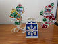 Santa & Angel Seesaw Light from Unknown (Possibly H.C. Company or a similar brand) - 1980s-1990s Holiday Decor (Plastic, Holographic Foil, Wiring Christmas Light Decoration, Christmas, Holiday, Retro, Kitsch, White, Red, Green, Blue, Yellow)