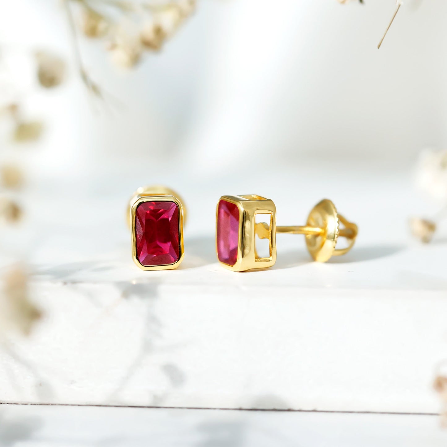 1.5 Carat Emerald Cut Lab Grown Ruby Stud Earrings in Bezel Set