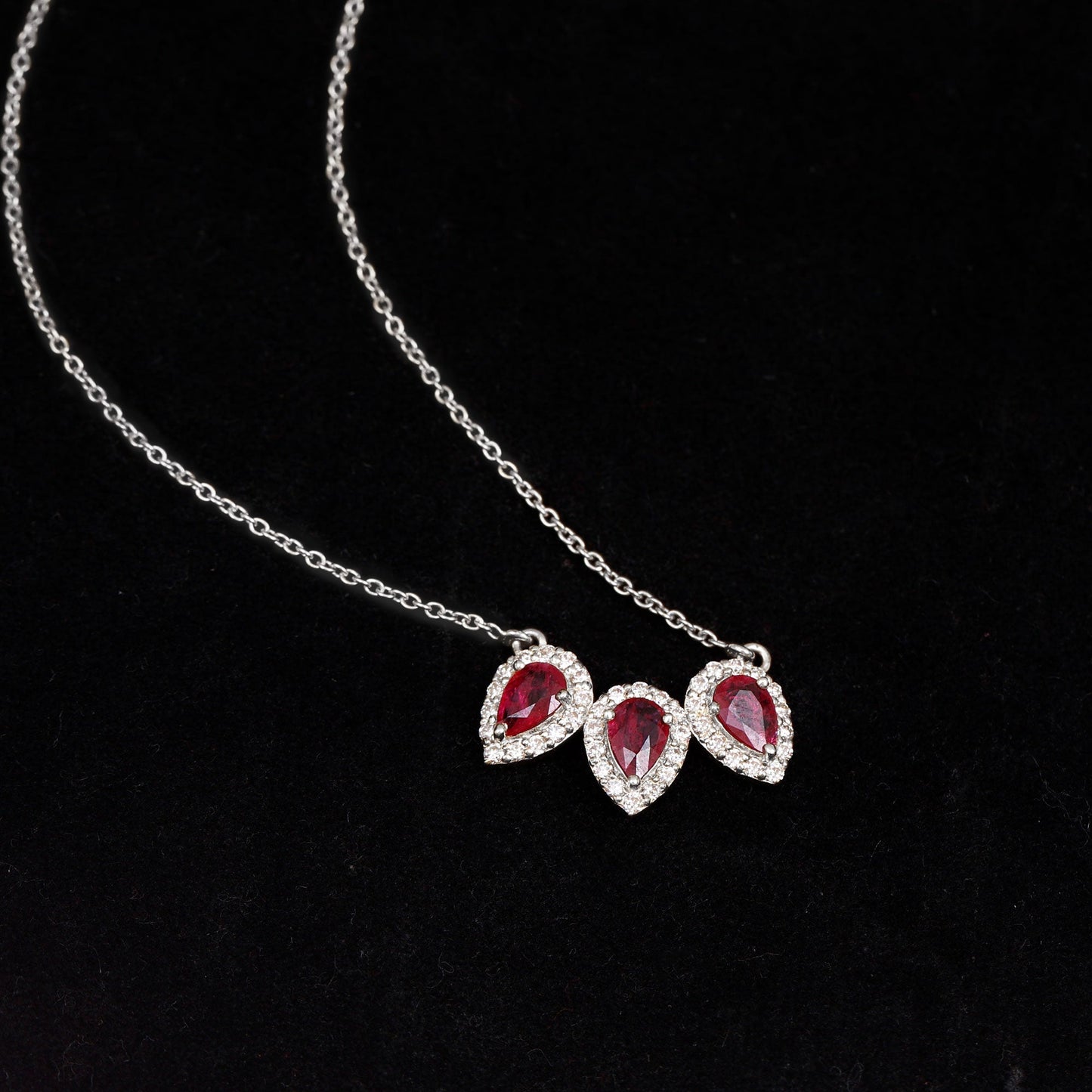 Pear Cut Lab Created Ruby Three Stone Necklace with Moissanite Halo