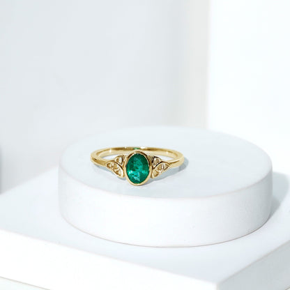 Oval Shaped Emerald Celtic Engagement Ring in Bezel Setting