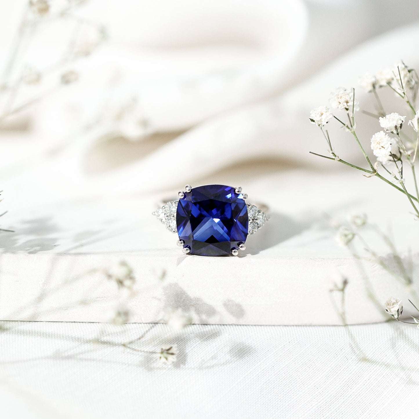 Certified 9 Carat Lab Grown Blue Sapphire Cushion Cut Engagement Ring with Diamond Trio