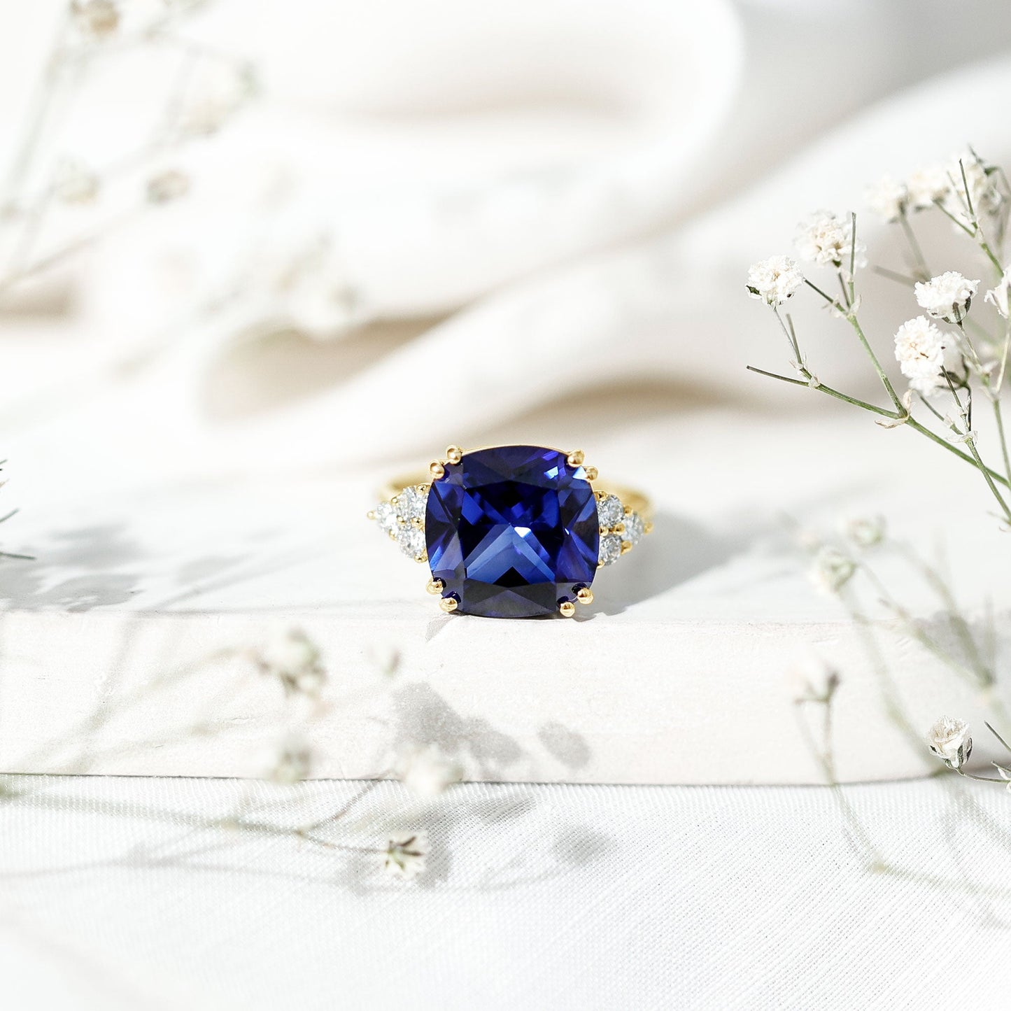 Certified 9 Carat Lab Grown Blue Sapphire Cushion Cut Engagement Ring with Diamond Trio