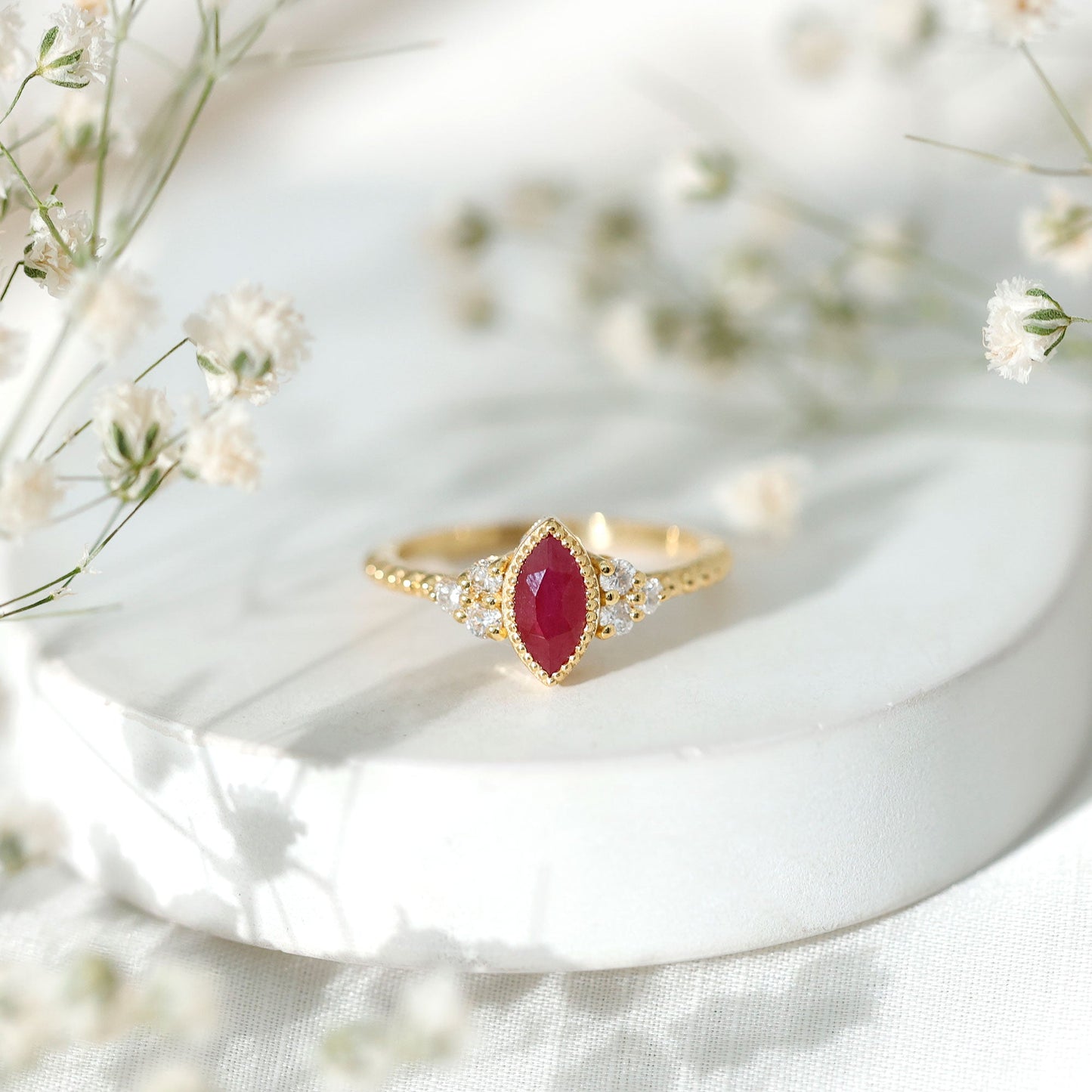 Vintage Style 0.75 Carat Ruby Marquise Engagement Ring with Diamond Trio