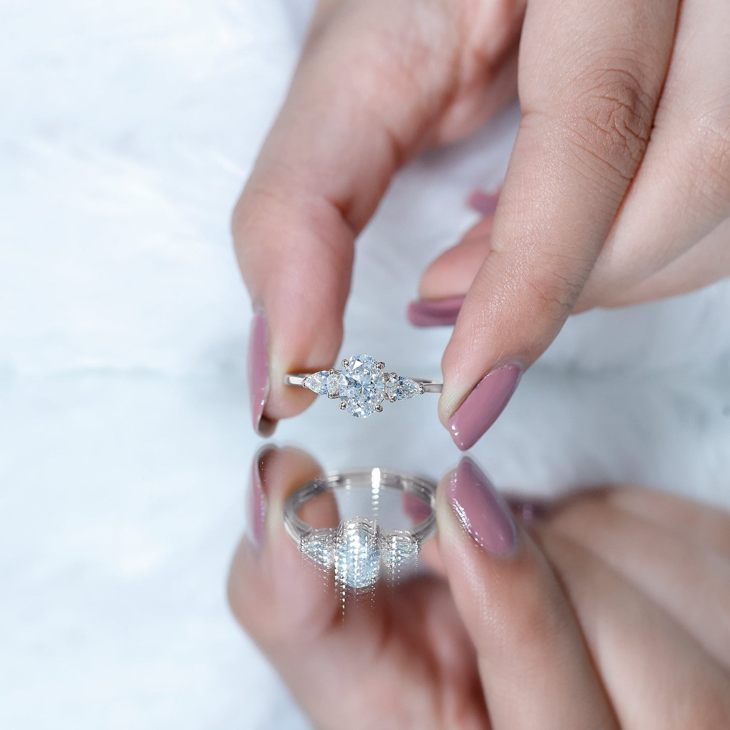 Oval and Pear Cut Moissanite Three Stone Engagement Ring