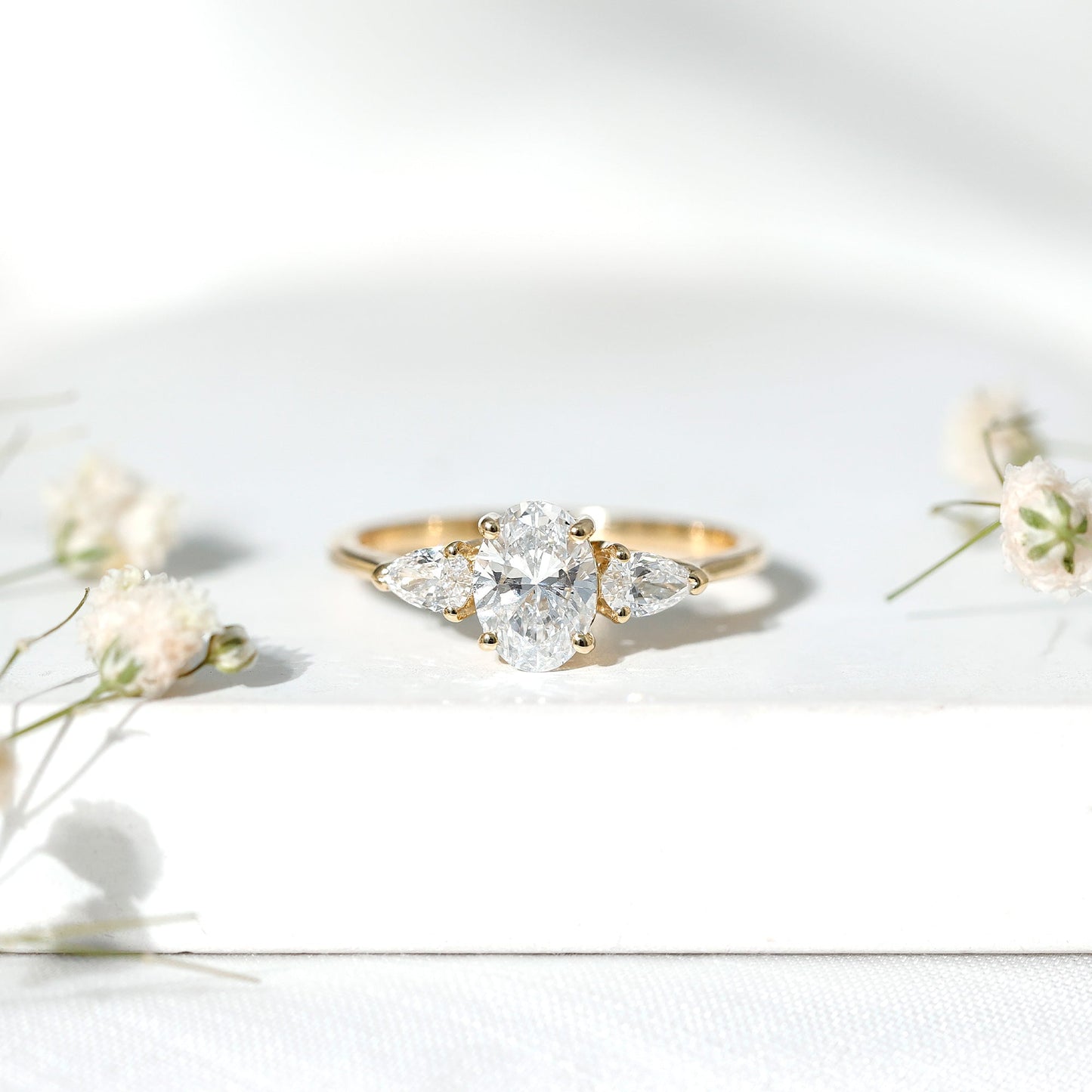 Oval and Pear Cut Moissanite Three Stone Engagement Ring