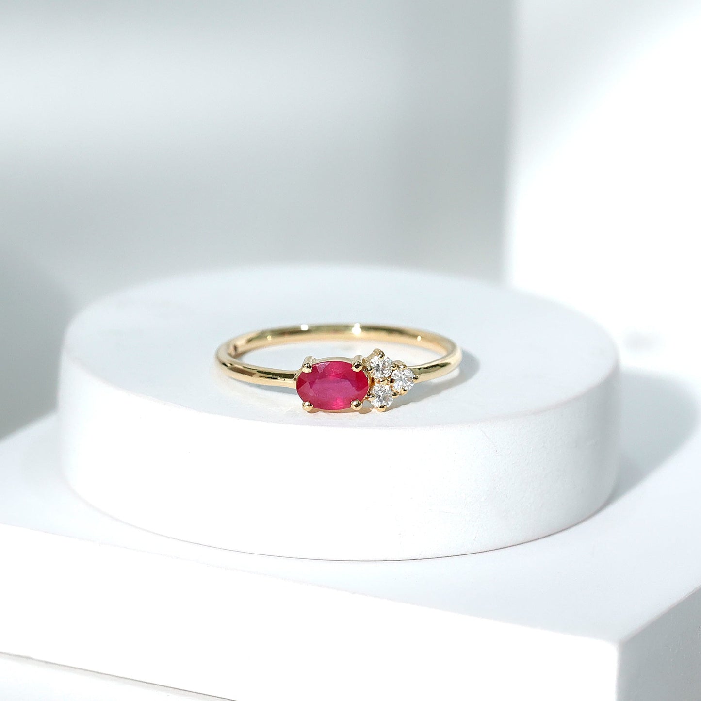 East West Style 0.6 Carat Oval Ruby Promise Ring with Diamond Trio