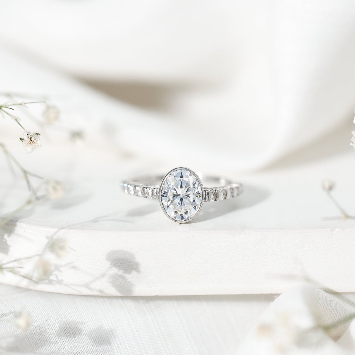 Bezel Set Moissanite Oval Engagement Ring with Side Stones