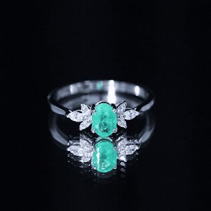 Oval Shaped Emerald Engagement Ring with Marquise Diamond Trio