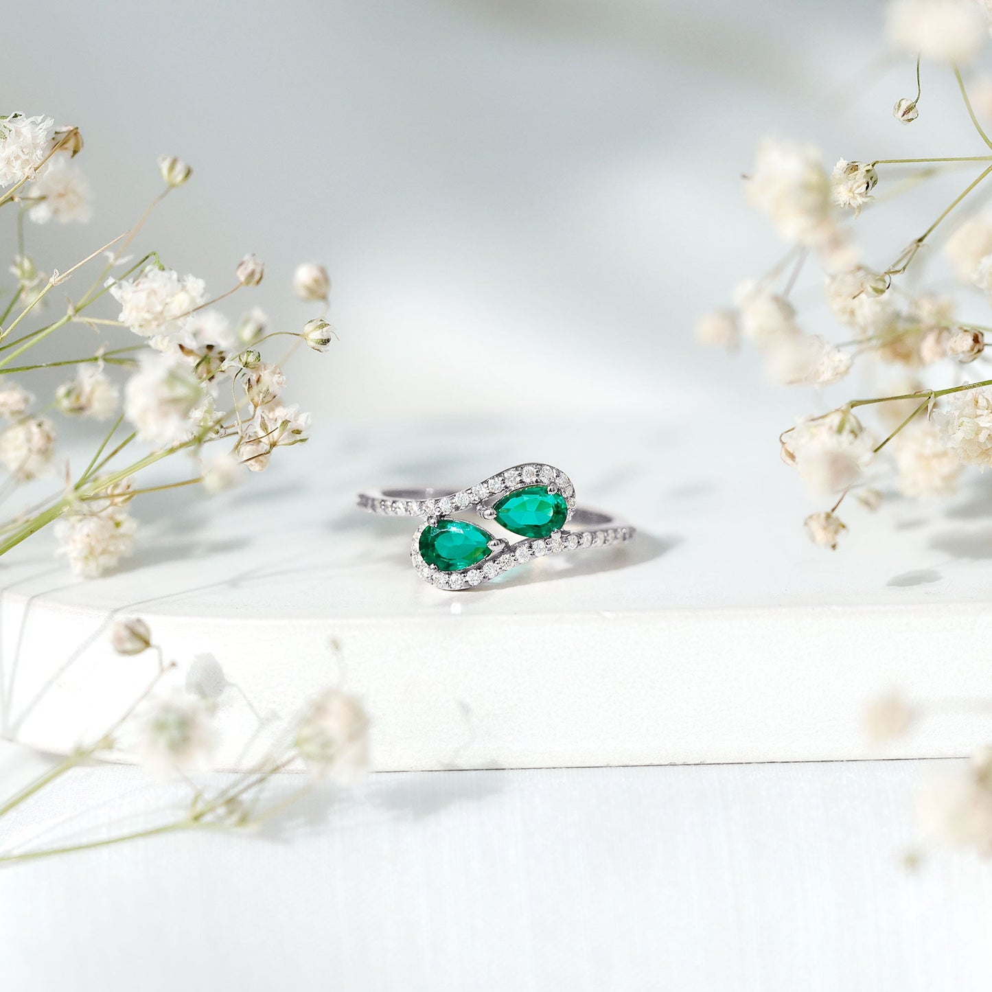 Pear Shape Created Emerald and Diamond Bypass Engagement Ring