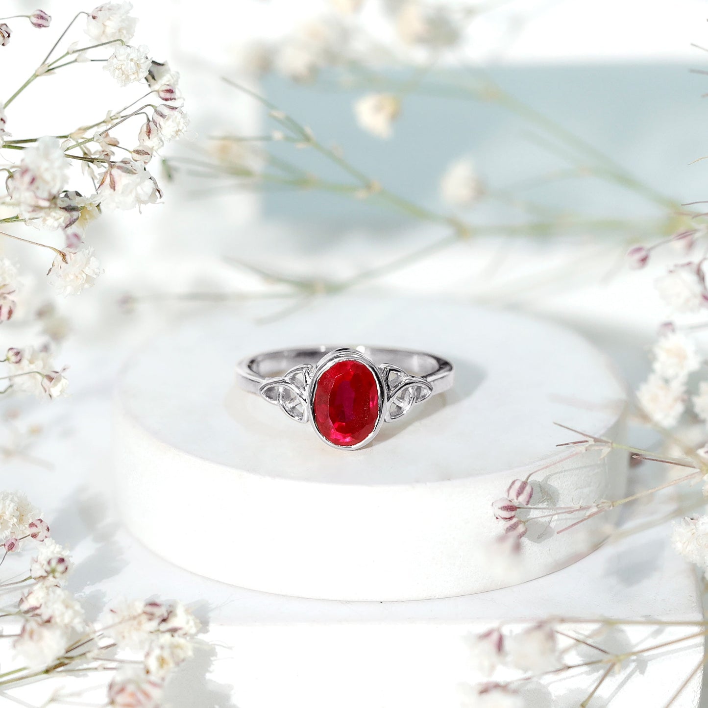 Oval Shaped 1.5 Carat Lab Grown Ruby Celtic Engagement Ring in Bezel Setting