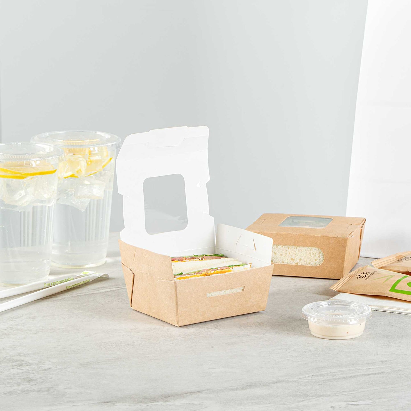 Cafe Vision 12 oz Rectangle Kraft Paper Mini Bio Take Out Container - Two Windows - 4 1/4" x 3 3/4" x 1 3/4" - 50 count box