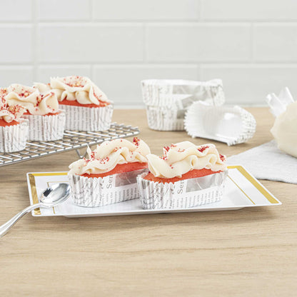 Panificio 1 oz Elliptical Newsprint Paper Regular Baking Cup - Ridged - 3 1/2" x 1 1/2" x 3/4" - 200 count box