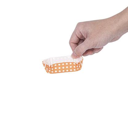 Panificio 1 oz Elliptical Polka-Dotted Hot Orange Paper Regular Baking Cup - Ridged - 3 1/2" x 1 1/2" x 3/4" - 200 count box