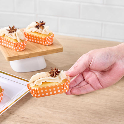 Panificio 1 oz Elliptical Polka-Dotted Hot Orange Paper Regular Baking Cup - Ridged - 3 1/2" x 1 1/2" x 3/4" - 200 count box