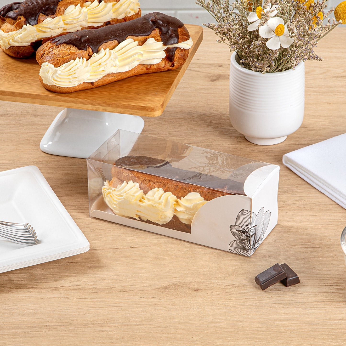 Sweet Vision Rectangle Clear Plastic Eclair Box - White Paper Sleeve, Lotus Accent - 7" x 2 1/2" x 2 1/2" - 100 count box