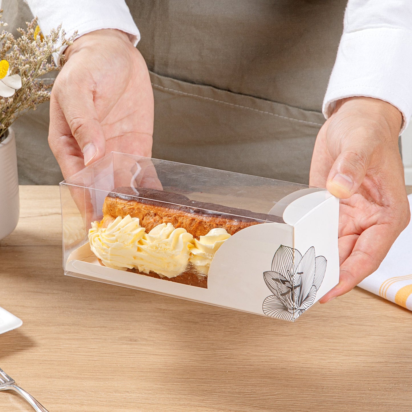 Sweet Vision Rectangle Clear Plastic Eclair Box - White Paper Sleeve, Lotus Accent - 7" x 2 1/2" x 2 1/2" - 100 count box