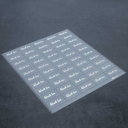 Label Tek Plastic Black Tea Label - Clear with White Font, Water-Resistant - 2" x 1" - 100 count box