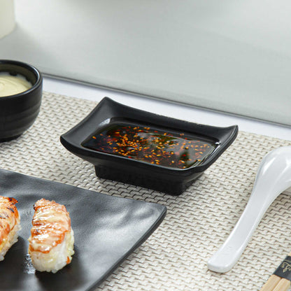 Voga 1 oz Rectangle Black Melamine Sauce Dish - Japonais - 4" x 2 1/2" x 1 1/4" - 10 count box