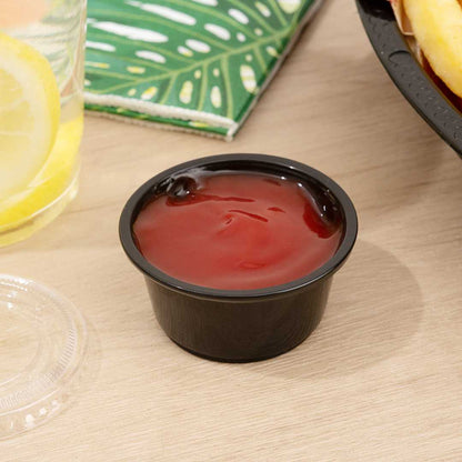 Chef 101 2 oz Round Black Plastic Portion Cup - 2 1/2" x 2 1/2" x 1 1/4" - 2000 count box