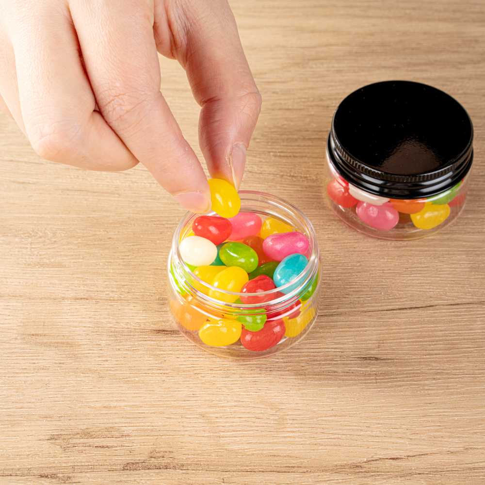 Chef 101 1 oz Round Clear Plastic Candy and Snack Jar - with Black Aluminum Lid - 2" x 2" x 1 1/4" - 100 count box