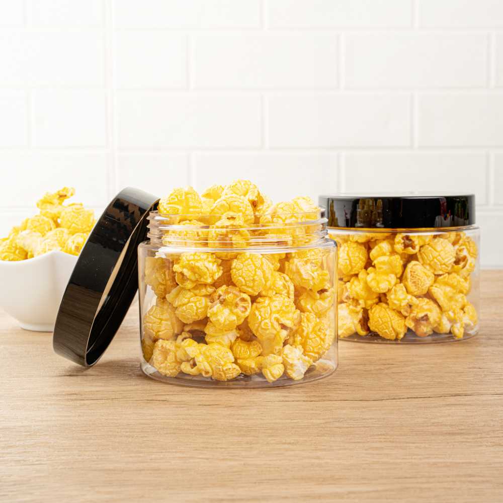 Chef 101 16 oz Round Clear Plastic Candy and Snack Jar - with Black Plastic Lid - 3 3/4" x 3 3/4" x 3" - 100 count box