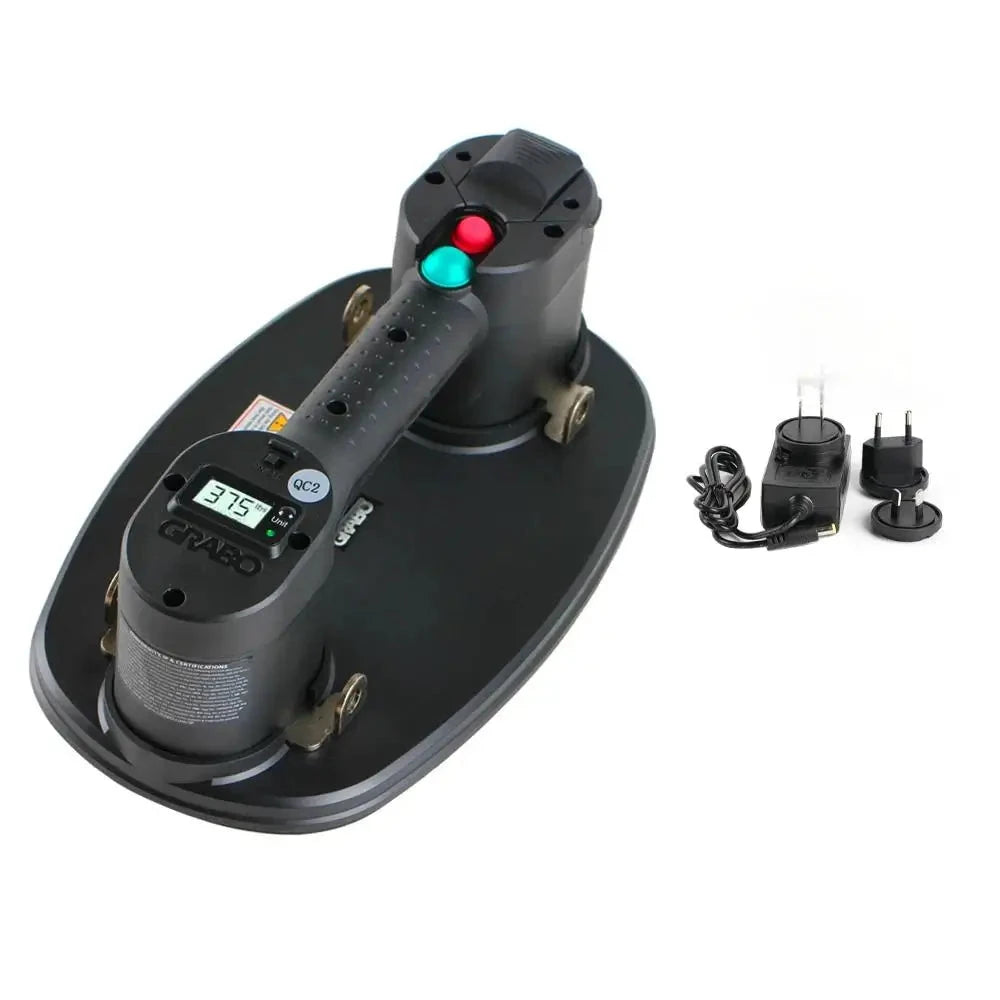 A black handheld electric tool with a digital display and red/green buttons, shown mounted on a matching black base. Two small black power adapters are placed to the right on a white background.