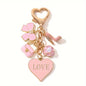 A Cute And Compact Pink Bag with a Heart-Shaped Oil Drop Keychain, Perfect As a Mini Decorative Accessory Or Gift for Cosmetics