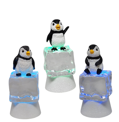 Penguin Sitting on Color-changing Lighted Icecube -